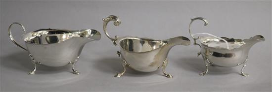 A small George III silver sauceboat (a.f.), London, 1767 and two 20th century silver sauceboats.